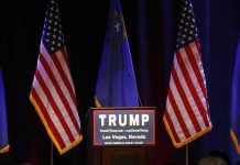 Podium with campaign sign between American flags
