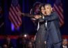 Michelle Obama and Rob Nabors pointing on stage at an event