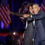 Michelle Obama and Rob Nabors pointing on stage at an event