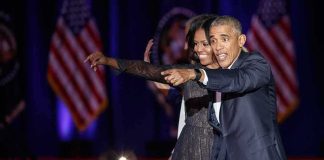 Old Obama Criticism Shadows El-Sayed Rally Michelle Obama and Rob Nabors pointing on stage at an event
