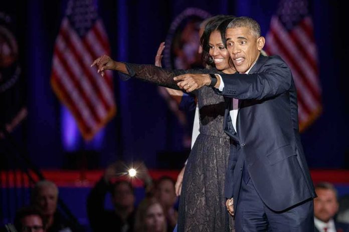 Michelle Obama and Rob Nabors pointing on stage at an event