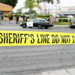 Bloody Ambush: Hollywood Actor Attacked yellow sheriff's line tape blocks a street near police cars