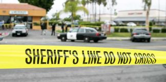 Bloody Ambush: Hollywood Actor Attacked yellow sheriff's line tape blocks a street near police cars