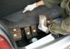 Person discovering wrapped packages in a car trunk