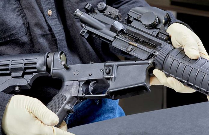 1088730455 featured image Person assembling a rifle with gloved hands