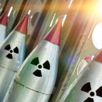 Line of nuclear missiles with radiation hazard signs