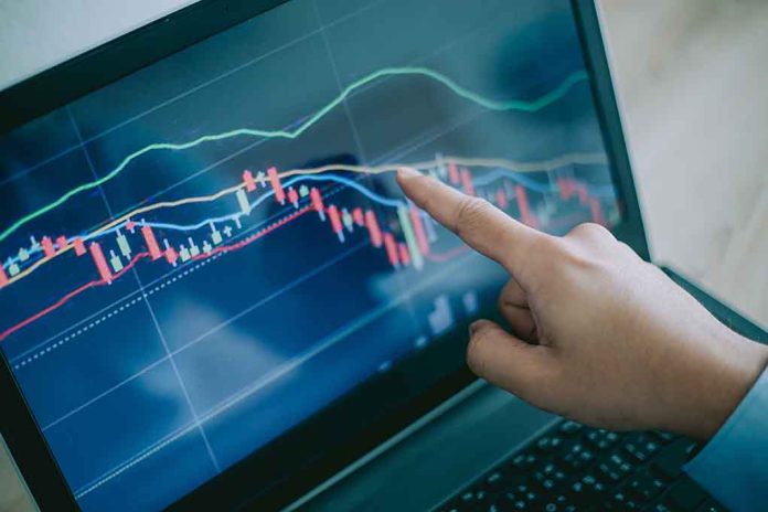 114313067 featured image Hand pointing at stock market graph on laptop screen