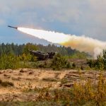 Military tank firing a missile in forest area
