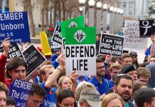 Pro-life rally with people holding various signs