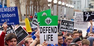 Pro-life rally with people holding various signs