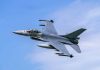 Jet fighter flying through clear blue sky