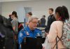 TSA agent checks passengers documents at airport security
