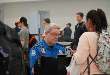 TSA agent checks passengers documents at airport security