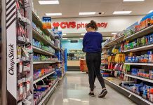 Person shopping in a CVS pharmacy aisle