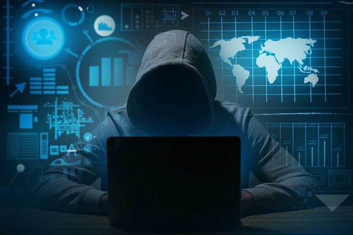 1669035211 featured image Hacker in hoodie using laptop with digital graphs