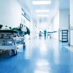Hospital hallway with a stretcher and medical staff