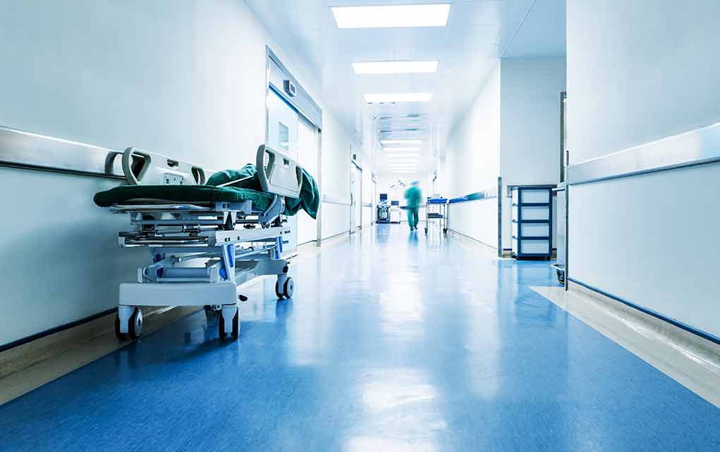 Hospital hallway with a stretcher and medical staff