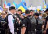 Police officers gathered near a crowd with flags