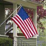 American flag hanging from a porch.