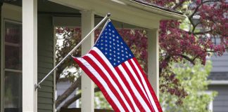 American flag hanging from a porch.