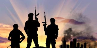 Silhouetted soldiers with rifles at sunset city background