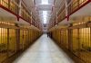 Long hallway with prison cells on both sides