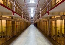 Long hallway with prison cells on both sides