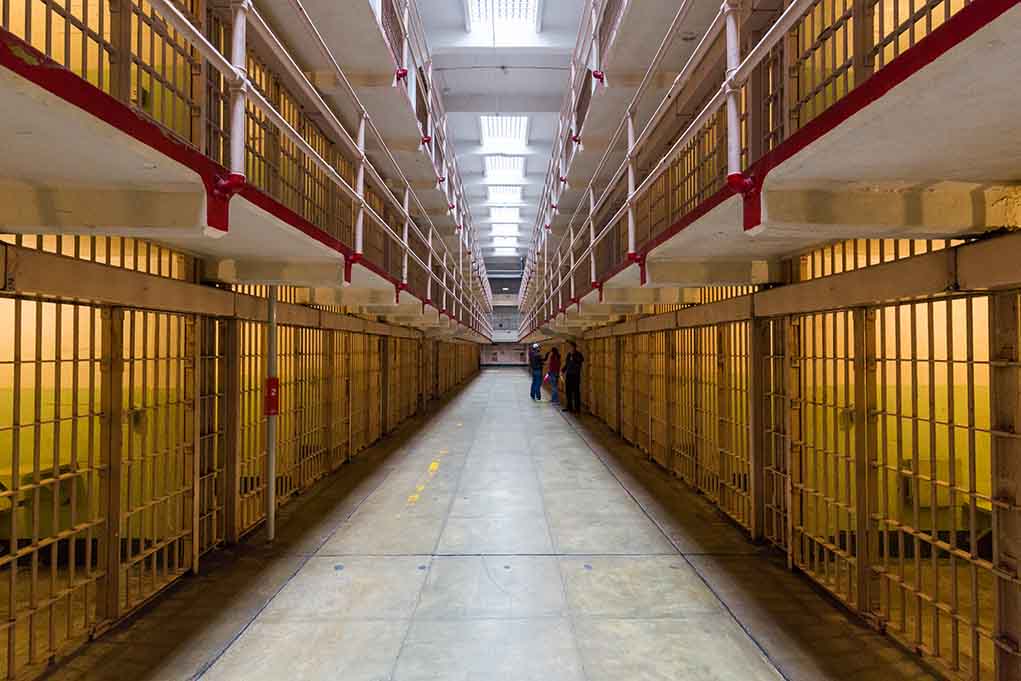 Long hallway with prison cells on both sides