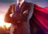 Businessman wearing a cape standing confidently