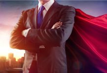 Businessman wearing a cape standing confidently