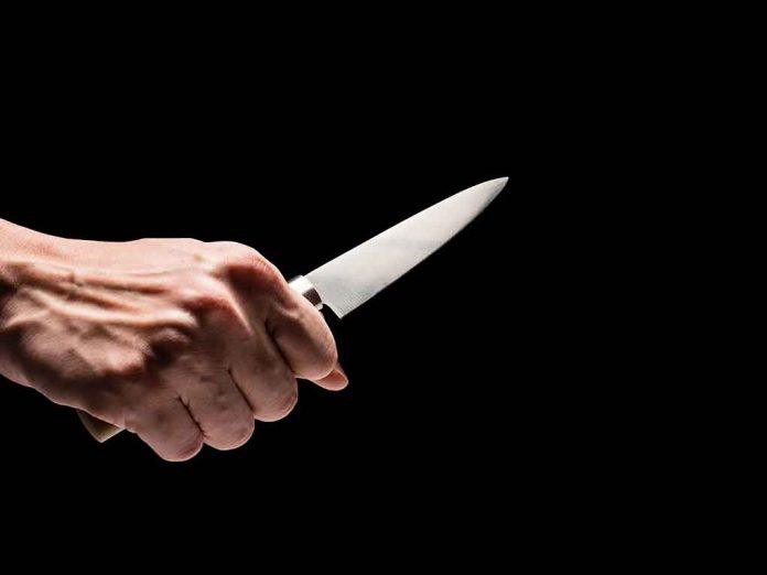 649767862 featured image Hand holding a knife against a black background