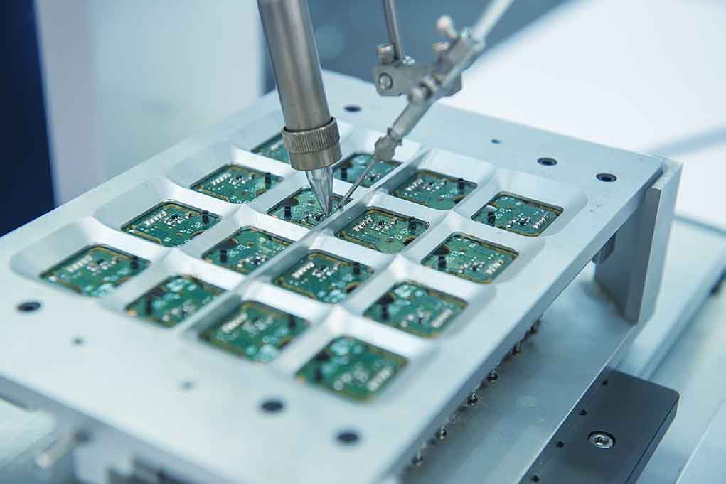 Robotic arm assembling electronic circuit boards in production