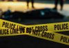Police tape marking a crime scene at night