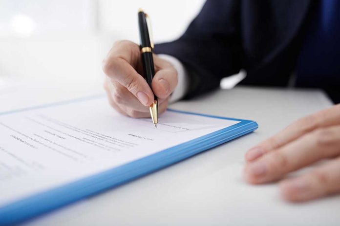 381270436 featured image Person signing a document with a pen