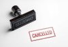 Cancelled stamp and red cancelled imprint on paper