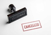 Cancelled stamp and red cancelled imprint on paper