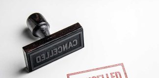 Cancelled stamp and red cancelled imprint on paper