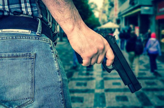 666476230 featured image Person holding a gun in a crowded street