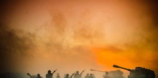 Soldiers and tanks in the foggy battlefield