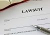 Lawsuit document with a pen and book