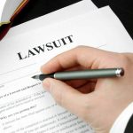 Filling out lawsuit form with pen