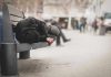 Person sleeping on a bench in a public area
