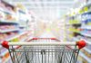 Shopping cart in aisle of grocery store