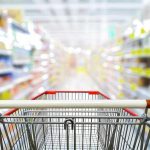 Shopping cart in aisle of grocery store