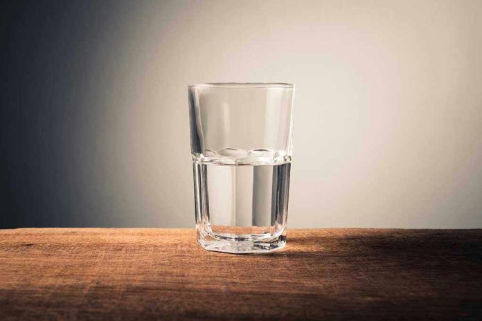 1695951943 Glass of water half full on table