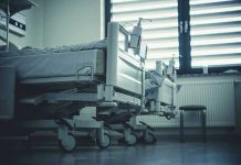 Empty hospital beds by a window