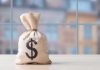Money bag with dollar sign on table