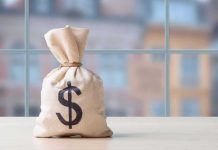Money bag with dollar sign on table