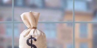 Money bag with dollar sign on table