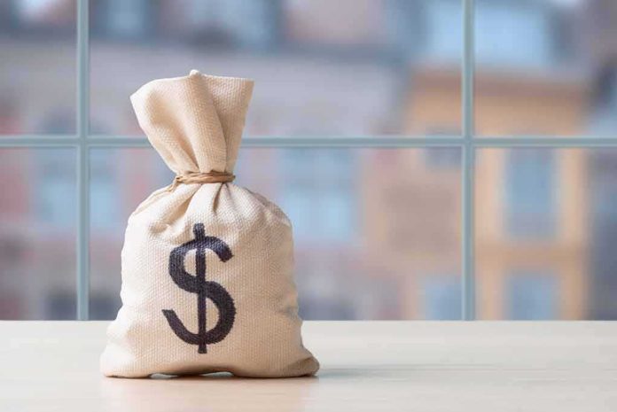 2425646037 featured image Money bag with dollar sign on table
